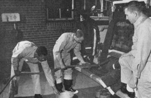 Uniformed men pulling the water pipe